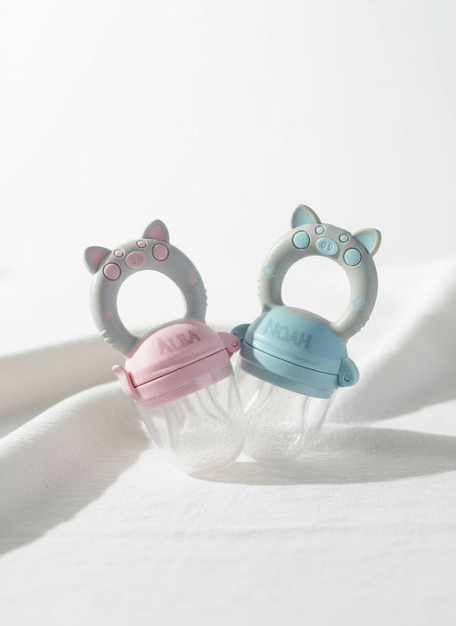 grignoteuse bébé en silicone rose et bleu pour découvrir les fruits frais en toute sécurité